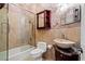 This bathroom features decorative wallpaper, a glass shower, and a carved vessel sink at 9616 Grand Isle Ln, Las Vegas, NV 89144