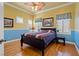 Cozy bedroom with bright yellow walls, blue trim, wood flooring, and ample natural light at 9616 Grand Isle Ln, Las Vegas, NV 89144
