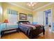 Bright, colorful bedroom with a ceiling fan, wood floors, and a connecting door to the bathroom at 9616 Grand Isle Ln, Las Vegas, NV 89144