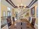Stunning dining room featuring a large table, chandelier, wet bar, and staircase at 9616 Grand Isle Ln, Las Vegas, NV 89144
