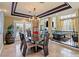 Open dining area with stylish table, chairs, modern lighting, and views of the game room at 9616 Grand Isle Ln, Las Vegas, NV 89144