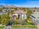 Beautiful exterior of a home with well-manicured landscaping and mountain views at 9616 Grand Isle Ln, Las Vegas, NV 89144