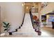 Elegant foyer with a grand staircase, high ceilings, and ornate detailing at 9616 Grand Isle Ln, Las Vegas, NV 89144