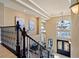 View of the bright and airy foyer with ornate railing, high ceilings, and decorative chandelier at 9616 Grand Isle Ln, Las Vegas, NV 89144