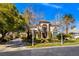 Charming home with well-maintained lawn and mature trees, showcasing inviting curb appeal at 9616 Grand Isle Ln, Las Vegas, NV 89144