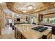 Expansive kitchen with stone arch, granite countertops, and seamless transition to the living areas at 9616 Grand Isle Ln, Las Vegas, NV 89144