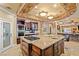 Gourmet kitchen with a large island, custom cabinets, stainless steel appliances, and brick accents at 9616 Grand Isle Ln, Las Vegas, NV 89144