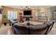 Comfortable living room boasts a stone fireplace, large sofa, and gaming machines at 9616 Grand Isle Ln, Las Vegas, NV 89144
