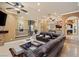 Spacious living room featuring a stone fireplace, spiral staircase, and leather furniture at 9616 Grand Isle Ln, Las Vegas, NV 89144