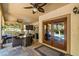 Charming covered patio featuring an outdoor kitchen, dining, and lounge area at 9616 Grand Isle Ln, Las Vegas, NV 89144