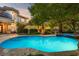 Stunning pool and spa oasis surrounded by manicured landscaping and mature palms at 9616 Grand Isle Ln, Las Vegas, NV 89144