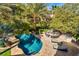 Aerial view of a backyard showcasing a sparkling pool, lounge chairs, and outdoor seating area at 9616 Grand Isle Ln, Las Vegas, NV 89144