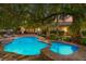 Inviting backyard pool and spa surrounded by lush greenery and mature trees at 9616 Grand Isle Ln, Las Vegas, NV 89144