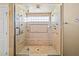 This is a spacious glass enclosed walk-in shower with multiple shower heads and a built-in bench at 9616 Grand Isle Ln, Las Vegas, NV 89144