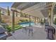 Inviting backyard with a pergola, swimming pool, and outdoor seating area at 9781 Arcadian Estate Ct, Las Vegas, NV 89141