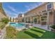 Beautiful backyard with a swimming pool, landscaped yard, and covered patio at 9781 Arcadian Estate Ct, Las Vegas, NV 89141