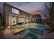Gorgeous backyard with a covered patio, sparkling pool, and lush landscaping, perfect for entertaining at 9781 Arcadian Estate Ct, Las Vegas, NV 89141