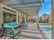 Spacious backyard patio with a pergola, outdoor seating, a barbeque, and a sparkling pool at 9781 Arcadian Estate Ct, Las Vegas, NV 89141