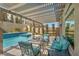 Relaxing backyard patio under a pergola with a pool, a spa, and comfortable outdoor seating at 9781 Arcadian Estate Ct, Las Vegas, NV 89141