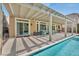 Backyard patio with a sparkling pool, outdoor seating, and a lovely pergola for shaded lounging at 9781 Arcadian Estate Ct, Las Vegas, NV 89141