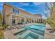 Beautiful backyard features a sparkling pool, covered patio, and a meticulously landscaped yard at 9781 Arcadian Estate Ct, Las Vegas, NV 89141