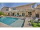 Backyard with a pergola, sparkling pool, meticulous landscaping, and multiple seating areas at 9781 Arcadian Estate Ct, Las Vegas, NV 89141