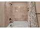 Classic tub and shower combo with neutral tile and bronze hardware at 9781 Arcadian Estate Ct, Las Vegas, NV 89141