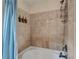 Elegant bathroom features tiled walls, a bathtub, and mounted soap dispensers at 9781 Arcadian Estate Ct, Las Vegas, NV 89141