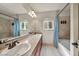Bathroom with double sinks and a large mirror and linen curtains at 9781 Arcadian Estate Ct, Las Vegas, NV 89141