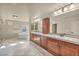 Bright bathroom featuring a soaking tub, double vanity, and updated fixtures at 9781 Arcadian Estate Ct, Las Vegas, NV 89141