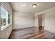 Bedroom featuring hardwood floors, a window, and a door to a closet at 9781 Arcadian Estate Ct, Las Vegas, NV 89141