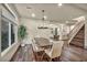 Bright dining room with hardwood floors, modern chandelier and staircase leading to the second level at 9781 Arcadian Estate Ct, Las Vegas, NV 89141