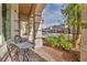 Welcoming front porch with a wrought iron table and chairs surrounded by lush landscaping at 9781 Arcadian Estate Ct, Las Vegas, NV 89141