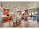 Well-lit kitchen featuring an island with stools and stainless steel appliances with access to the backyard pool at 9781 Arcadian Estate Ct, Las Vegas, NV 89141