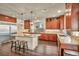 An open kitchen area with granite countertops, stainless steel appliances and wooden cabinetry at 9781 Arcadian Estate Ct, Las Vegas, NV 89141
