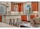 Open-concept kitchen features wooden cabinets, granite counters, stainless appliances, and access to a cozy living space at 9781 Arcadian Estate Ct, Las Vegas, NV 89141