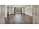 Spacious living room featuring hardwood floors, a bright window, and neutral walls at 9781 Arcadian Estate Ct, Las Vegas, NV 89141