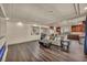 Spacious living room with hardwood floors, modern fireplace and kitchen view at 9781 Arcadian Estate Ct, Las Vegas, NV 89141