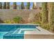 Close up of a pool and spa with tile surround, landscaped accents, and privacy trees at 9781 Arcadian Estate Ct, Las Vegas, NV 89141