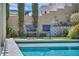 Relaxing pool area with comfortable seating and tall, elegant trees providing shade and beauty at 9781 Arcadian Estate Ct, Las Vegas, NV 89141