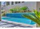 Beautifully designed pool with blue tile, complemented by manicured greenery and a serene ambiance at 9781 Arcadian Estate Ct, Las Vegas, NV 89141