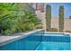Inviting pool with blue tile accents and lush landscaping, creating a serene outdoor oasis at 9781 Arcadian Estate Ct, Las Vegas, NV 89141