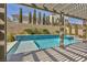 Inviting backyard pool with a tiled water feature, a spa, and lush privacy landscaping at 9781 Arcadian Estate Ct, Las Vegas, NV 89141