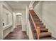 Wide shot of wooden stairs and landing with decorative wooden and iron banister at 9781 Arcadian Estate Ct, Las Vegas, NV 89141