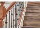 Beautiful staircase features dark wood treads, a white stringer, and decorative black iron balusters at 9781 Arcadian Estate Ct, Las Vegas, NV 89141