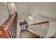 Wide shot of the staircase with wood treads and decorative wood and iron banister at 9781 Arcadian Estate Ct, Las Vegas, NV 89141