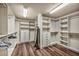 Large walk-in closet featuring built-in shelves, drawers, and ample storage at 9781 Arcadian Estate Ct, Las Vegas, NV 89141