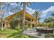 Luxury home with a lush backyard, patio, lounge seating, and an outdoor pool at 9909 Moon Valley Pl, Las Vegas, NV 89134