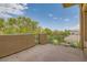 Spacious balcony with wrought iron railings and scenic tree-filled views at 9909 Moon Valley Pl, Las Vegas, NV 89134