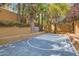 Private basketball court in a well maintained backyard with surrounding trees at 9909 Moon Valley Pl, Las Vegas, NV 89134